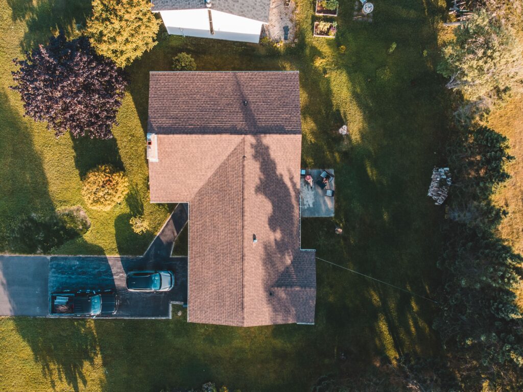 Aerial view of a finished asphalt shingle roof on a home, the result of professional Twin Cities roofing services.