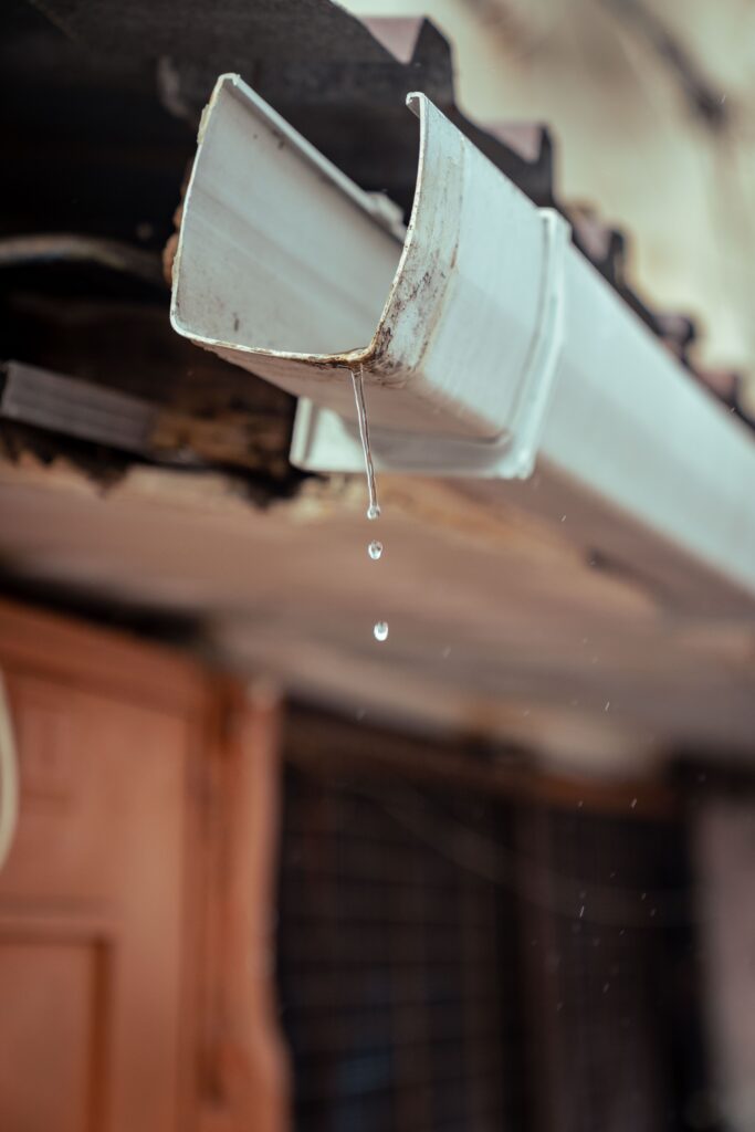 Water dripping from a worn gutter, a sign it may need gutter repair in the Twin Cities.