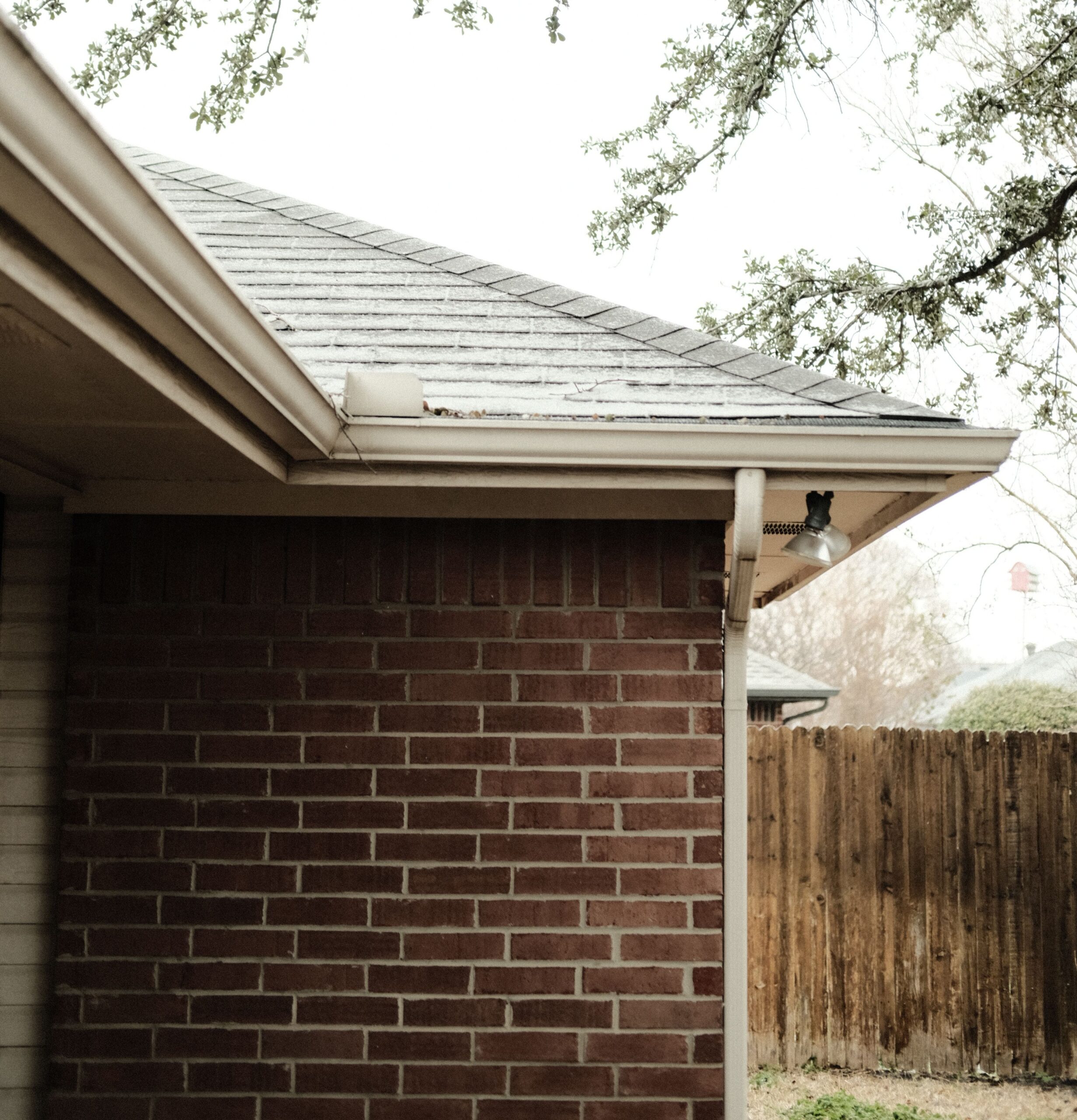 Gutters along the roofline of a brick home, the kind Lakeside Roofing & Remodeling installs across the Twin Cities.